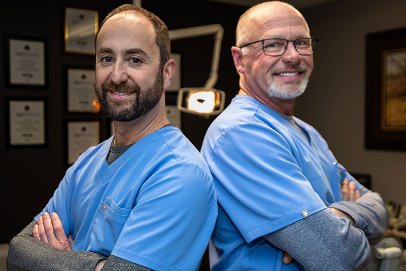 both doctors smiling together within the dental center