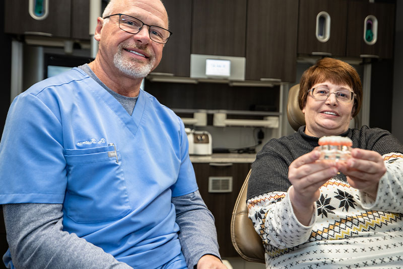 patient and doctor holding full mouth dental implant
