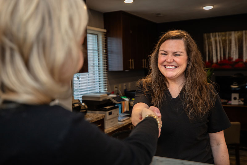 staff member shaking hands with patient