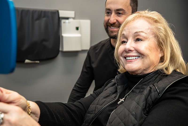 patient smiling brightly after their dental treatment within the dental center