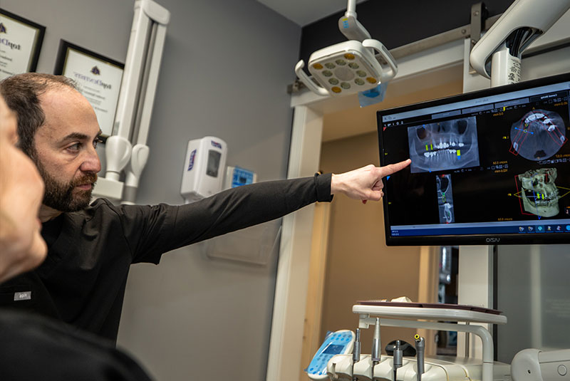 patient and doctor looking over dental implant procedure