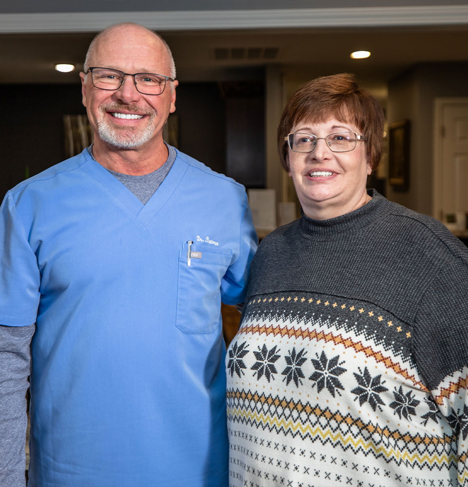 doctor and patient smiling brightly within the dental center after patient's dental treatment